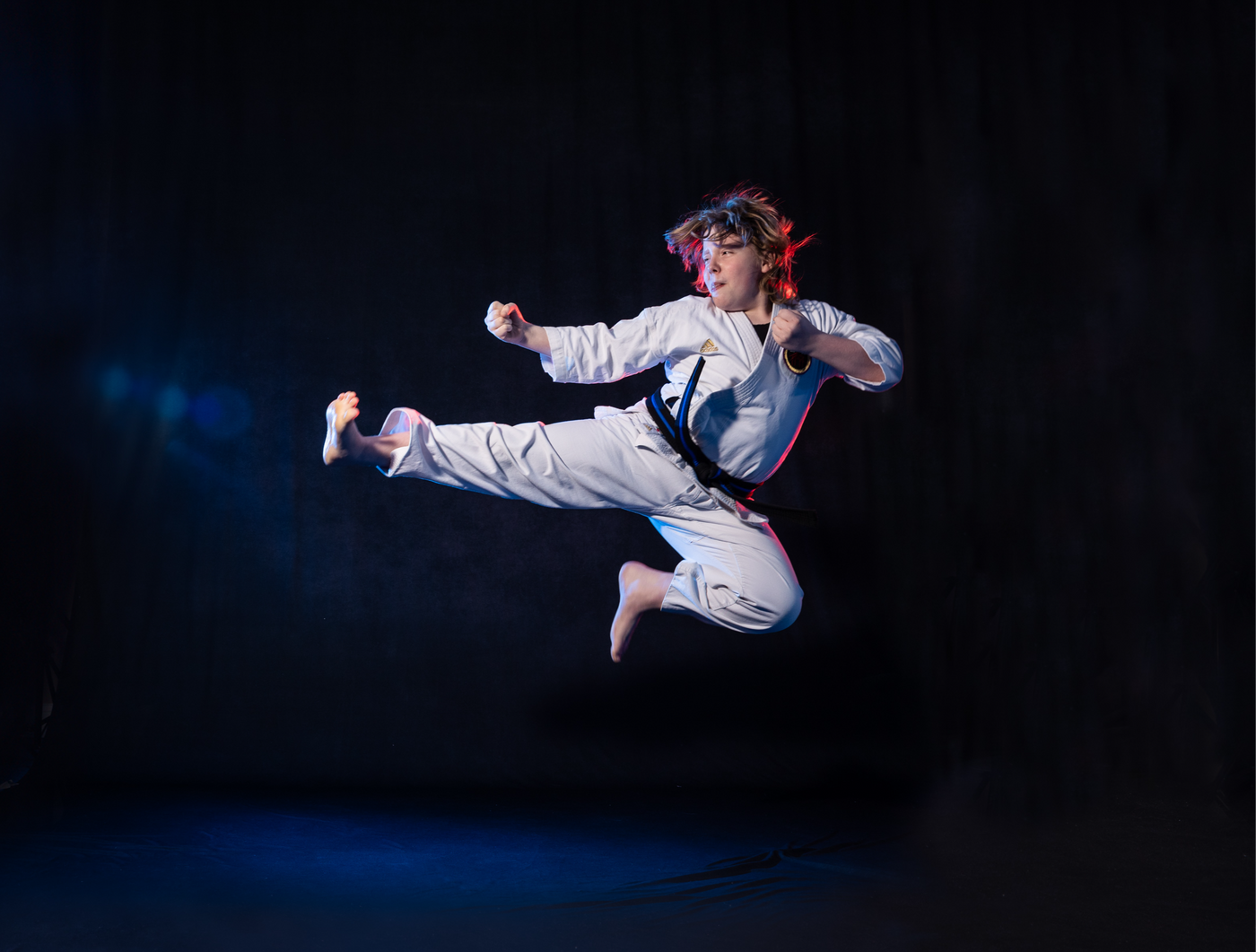 Karate student executing a flying side kick